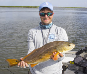 Captain Devin holding Redfish